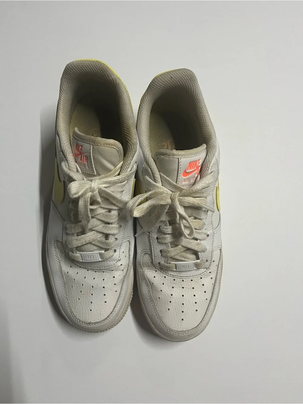 Nike White Low-Top Sneakers with Yellow Swoosh